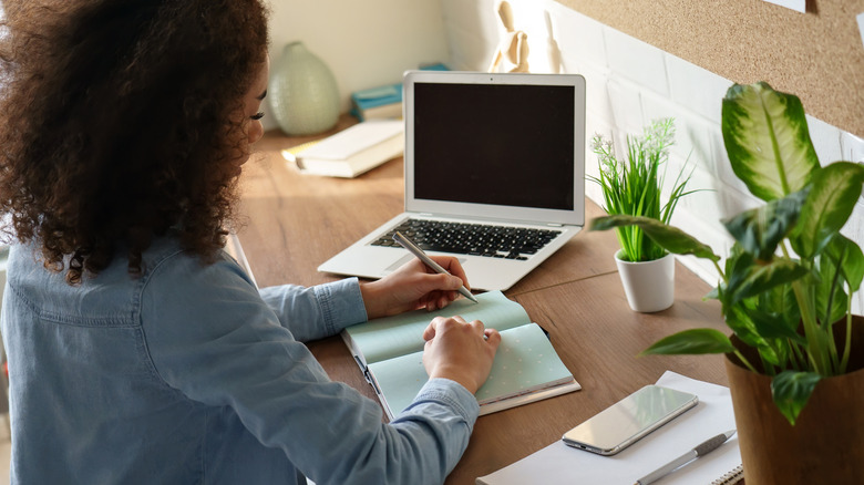 A woman making handwritten notes