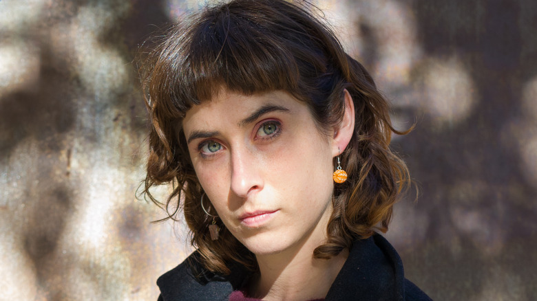 A person with a shullet standing outside