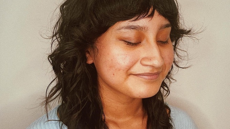 A woman smiling with a shullet