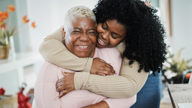 two happy women hugging