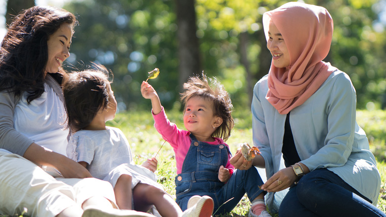Two women and their children at the park