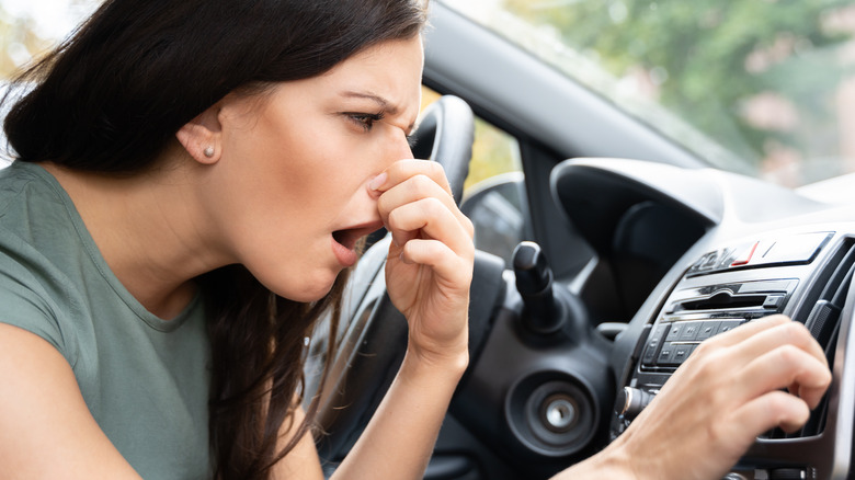 woman plugging her nose