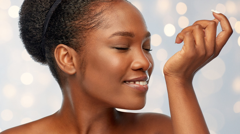 female smelling her wrist
