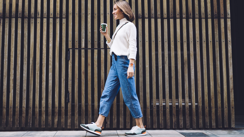woman walking wearing sneakers