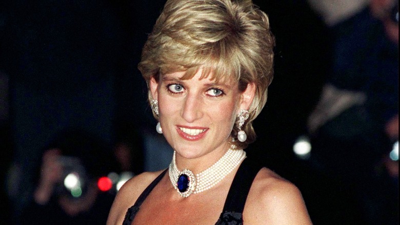 Princess Diana photographed wearing her 1994 revenge dress with ornate jewelry.