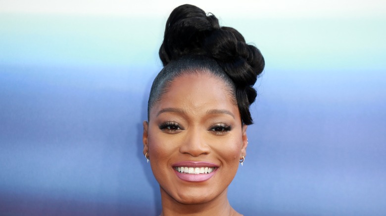 Keke Palmer smiles at a premiere