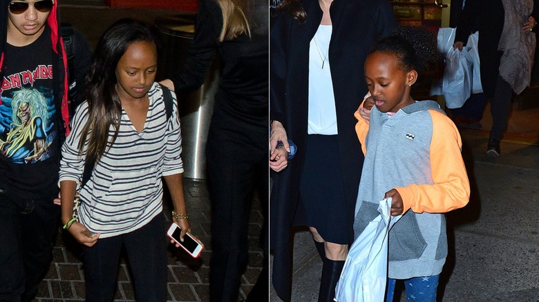 Zahara Jolie-Pitt in 2014 with straight hair and her hair up in a ponytail.