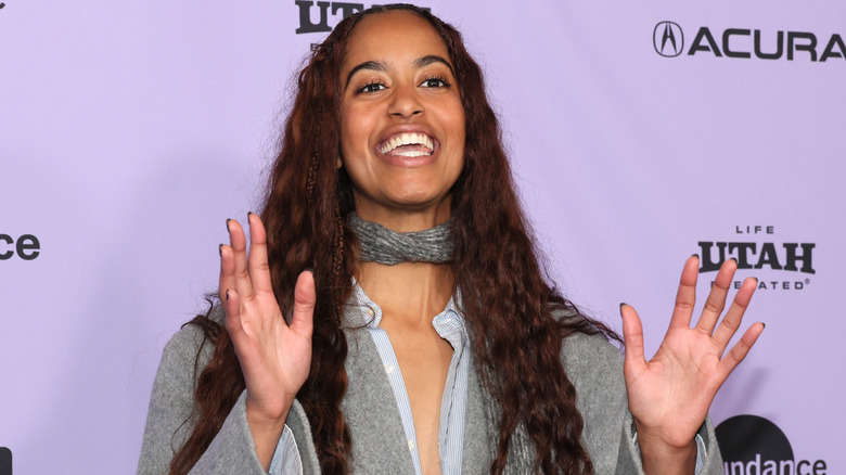 Malia Obama walking a Sundance red carpet in a gray outfit