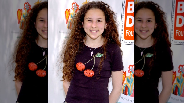 Preteen Hallie Eisenberg smiles for cameras at an event