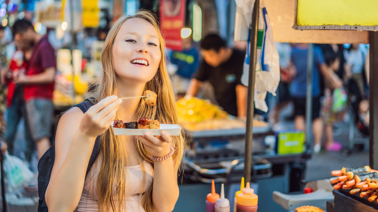 woman eating street food in Seoul