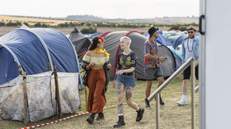 people walking in field at music festival
