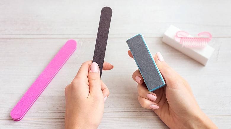 hands holding nail file