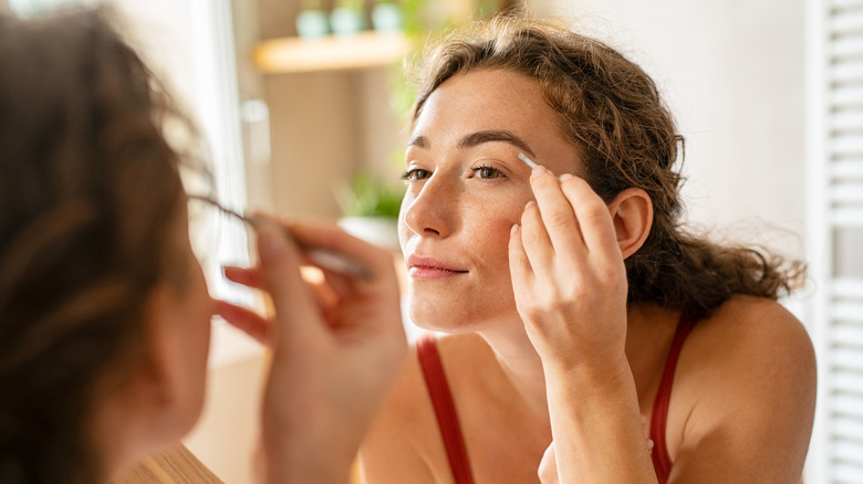 woman using tweezers