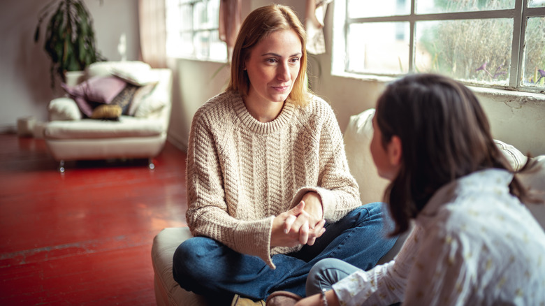 Woman listening to friend speak