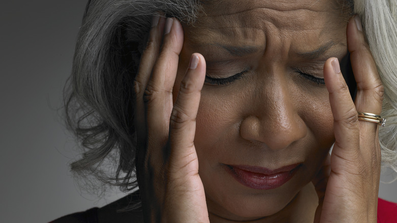 woman holding sides of her face
