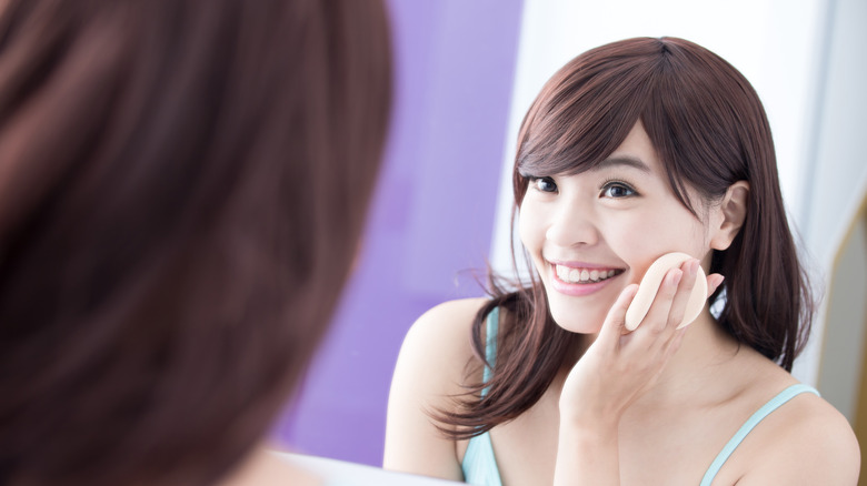 person using a makeup sponge