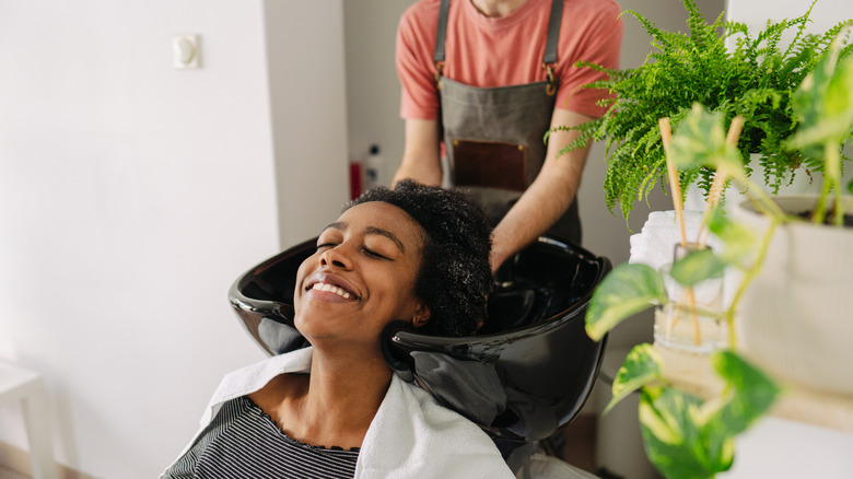 woman washing hair in salon