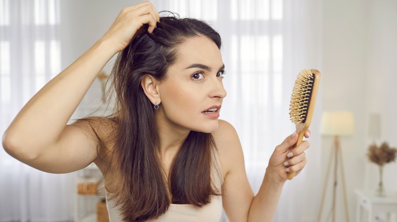 woman inspecting scalp