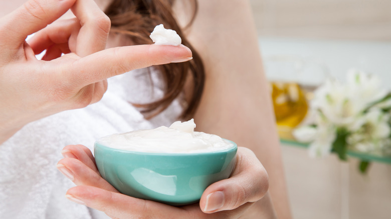 person applying product to hair