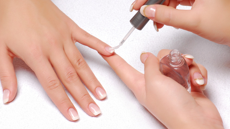 woman applying clear top coat