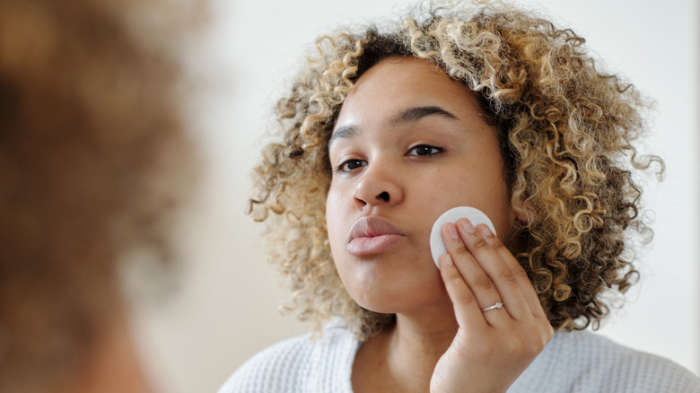 woman cleansing face