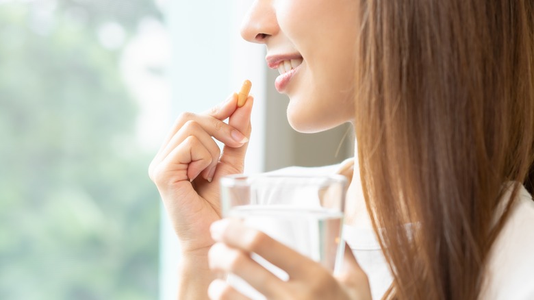 Woman taking vitamin