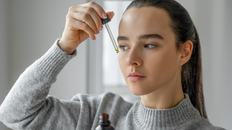 Woman using an exfoliating serum