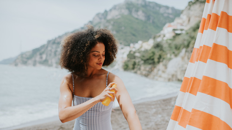 Woman applying sunscreen