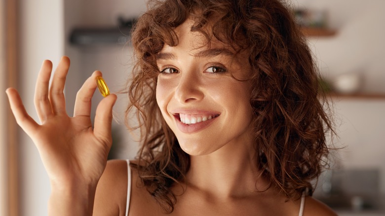 Woman holding a vitamin
