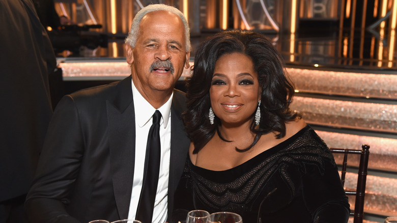 Oprah Winfrey and Stedman Graham smiling while wearing black outfits