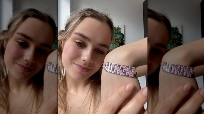 woman showing Barbie bracelet