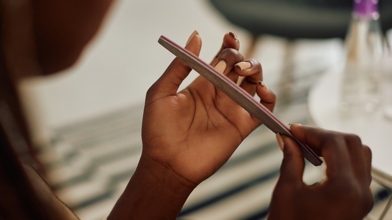 Woman filing nails