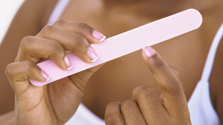 Woman filing her nails