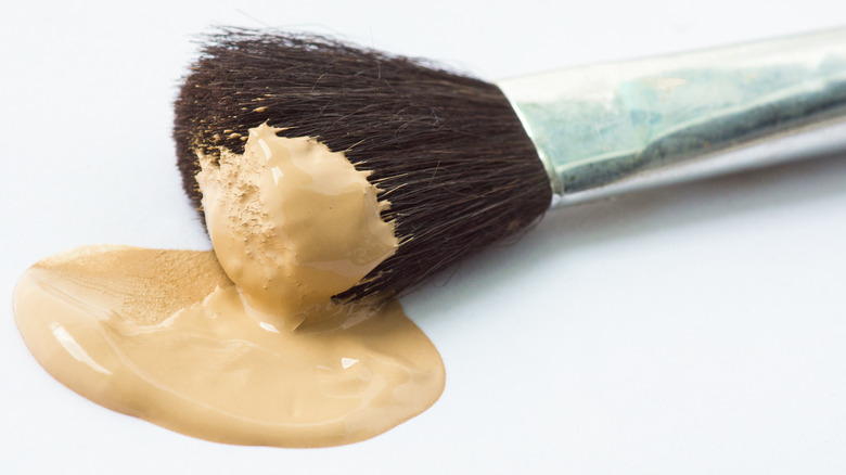 Makeup brush with foundation on it