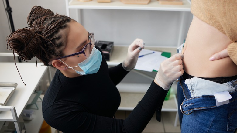 Professional piercing person's belly button