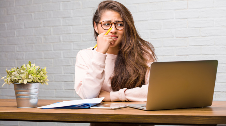 Woman reading something on her laptop that's making her nervous