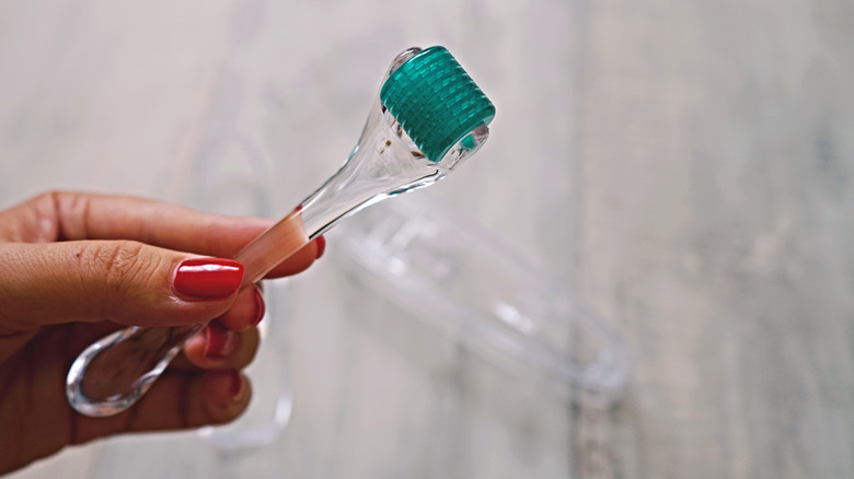 a hand holding a dermaroller