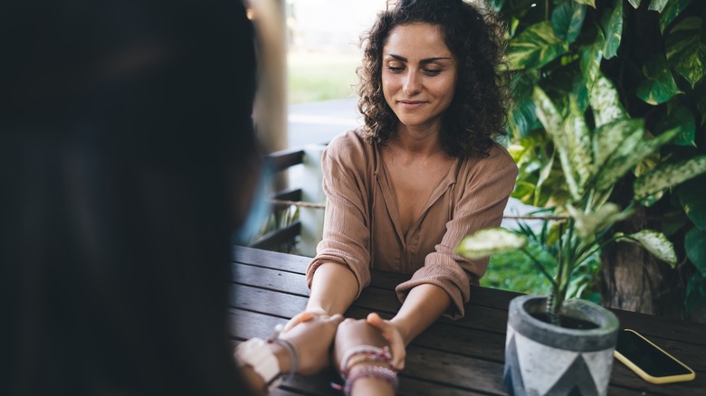 two women holding hands