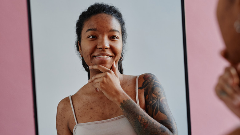 woman with tattoos in mirror