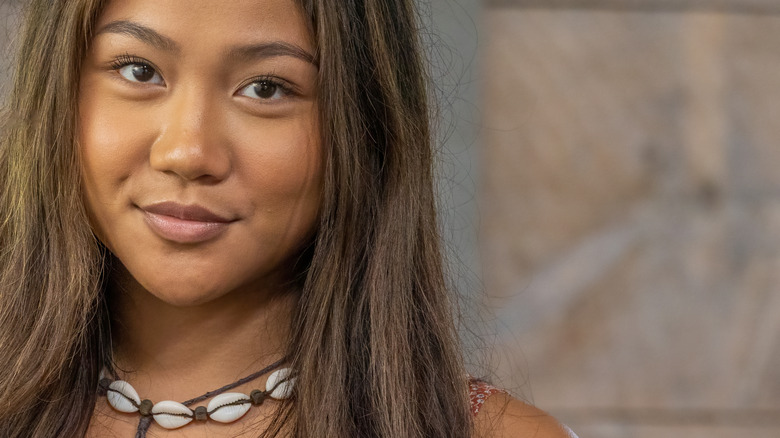 Woman wears shell necklace