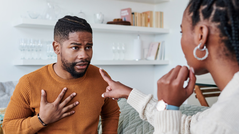 upset woman pointing at man