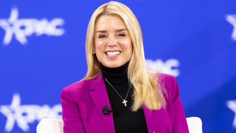 Pam Bondi wearing a magenta suit and turtleneck