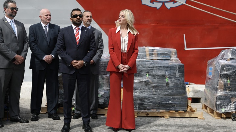 Pam Bondi wearing a red suit with a white shirt
