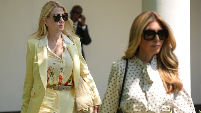 Pam Bondi wearing a yellow suit with a printed shirt