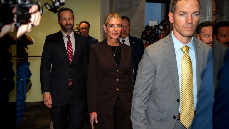 Pam Bondi wearing a brown suit with her hair up