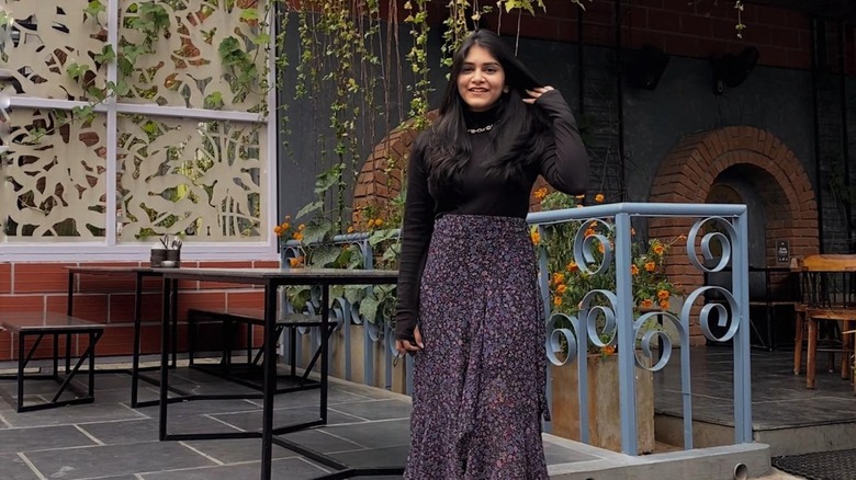 woman wearing dark floral skirt