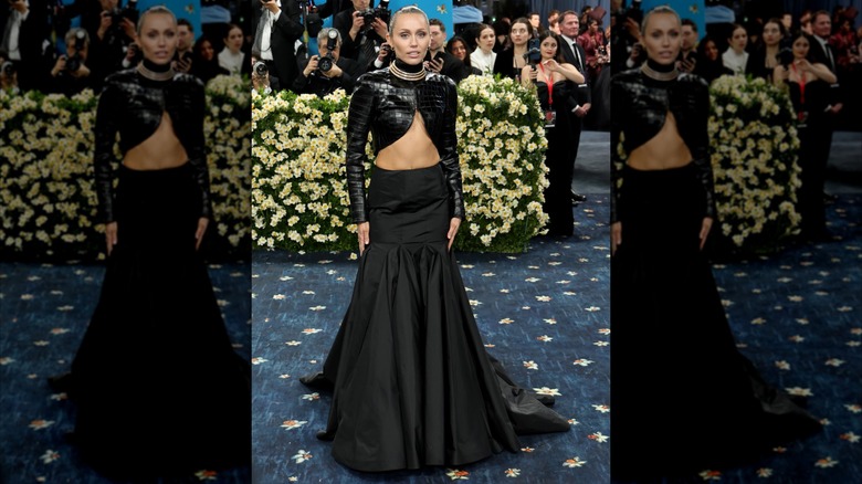 Miley Cyrus wearing a black outfit with clashing fabrics at the 2025 Met Gala