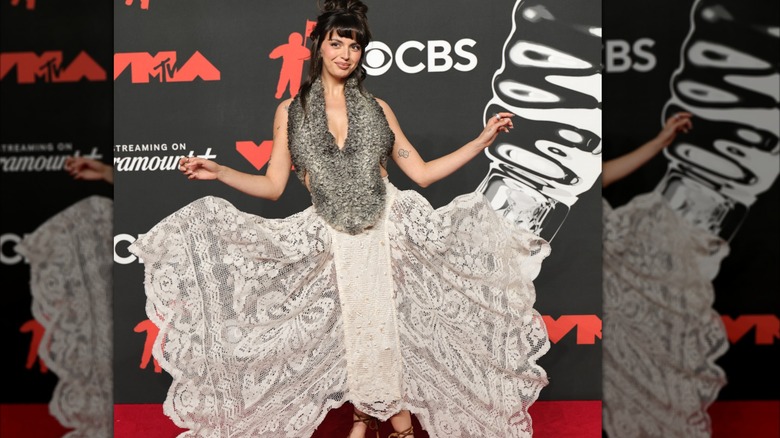 Rebecca Black shows off her skirt on the red carpet