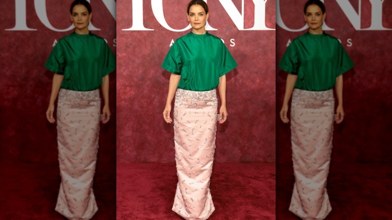 Katie Holmes arrives at the Tony Awards in a green top and pink skirt