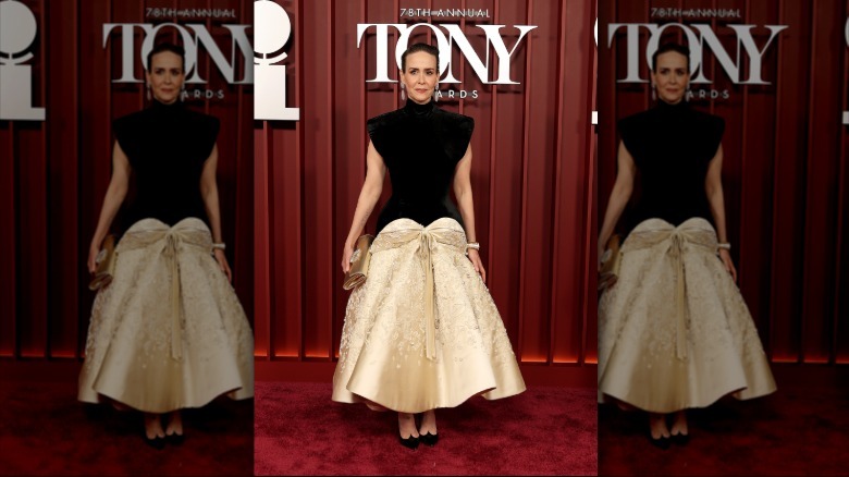 Sarah Paulson poses on the red carpet at the Tony Awards in a black and silk dress